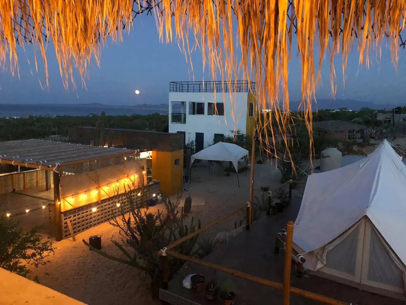 Casa Xolo glowing at dusk beside La Ventana Bay